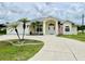 House exterior features a beige color, and a welcoming front porch at 530 Kensington St, Port Charlotte, FL 33954