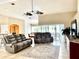Relaxing living room with large screen TV and reclining furniture at 530 Kensington St, Port Charlotte, FL 33954