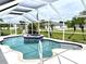 Inviting swimming pool with spa and screened enclosure at 530 Kensington St, Port Charlotte, FL 33954