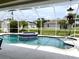 Enclosed pool and spa with a view of the backyard at 530 Kensington St, Port Charlotte, FL 33954