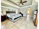 Main bedroom with king bed, recliner, and ensuite bathroom access at 530 Kensington St, Port Charlotte, FL 33954