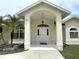 Front entrance with arched entryway and attractive landscaping at 530 Kensington St, Port Charlotte, FL 33954