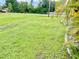 Spacious side yard with grassy area and partial view of home at 530 Kensington St, Port Charlotte, FL 33954