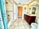 Bathroom with single vanity, tub, and tiled floor at 530 Kensington St, Port Charlotte, FL 33954