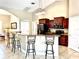 Kitchen features dark wood cabinets, granite countertops, and stainless steel appliances at 530 Kensington St, Port Charlotte, FL 33954