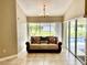 Cozy sitting area with a comfortable sofa and pool views at 530 Kensington St, Port Charlotte, FL 33954