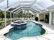 Large screened-in pool with built-in spa at 530 Kensington St, Port Charlotte, FL 33954