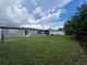 Spacious backyard featuring a patio and lush lawn at 1405 Dorchester St, Port Charlotte, FL 33952
