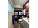Bright bathroom features a shower with a blue and white curtain and modern vanity with sink at 1405 Dorchester St, Port Charlotte, FL 33952