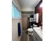 This bathroom features a shower with a blue and white curtain, and a white cabinet at 1405 Dorchester St, Port Charlotte, FL 33952