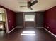 A serene bedroom offers wood floors, gray walls, window and ceiling fan at 1405 Dorchester St, Port Charlotte, FL 33952