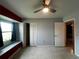 Spacious bedroom with a ceiling fan, window seat, and closet at 1405 Dorchester St, Port Charlotte, FL 33952