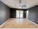 An empty bedroom with dark walls, a ceiling fan, and french doors at 1405 Dorchester St, Port Charlotte, FL 33952