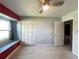 A bedroom features ample natural light, closet space, ceiling fan, and neutral walls to suit any decor at 1405 Dorchester St, Port Charlotte, FL 33952