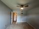 Bright bedroom with a ceiling fan, neutral walls, and doorway leading to another room at 1405 Dorchester St, Port Charlotte, FL 33952