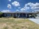 Inviting single-Gathering home featuring a covered carport, screened porch, and a pleasant front yard at 1405 Dorchester St, Port Charlotte, FL 33952