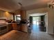 Open kitchen with wood cabinets, modern appliances, and easy access to the dining area at 1405 Dorchester St, Port Charlotte, FL 33952