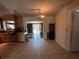 Traditional-style kitchen with a view to a dining area and sliding glass doors leading to the outdoors at 1405 Dorchester St, Port Charlotte, FL 33952
