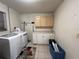 Functional laundry room featuring cabinetry, countertop, and modern washer and dryer at 1405 Dorchester St, Port Charlotte, FL 33952