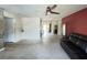 Spacious living room featuring a ceiling fan and easy access to the backyard at 1405 Dorchester St, Port Charlotte, FL 33952