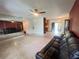 Open-concept living room boasts mirrored wall, tile flooring and a modern sofa at 1405 Dorchester St, Port Charlotte, FL 33952