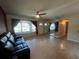 Inviting living room with terrazzo floors, large window, ceiling fan, and plenty of space at 1405 Dorchester St, Port Charlotte, FL 33952