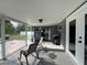 Relaxing screened patio area with rocking chairs and backyard access at 1405 Dorchester St, Port Charlotte, FL 33952