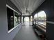 Spacious porch featuring ceiling fan, neutral paint, and open layout with windows and screens at 1405 Dorchester St, Port Charlotte, FL 33952