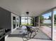 Relaxing screened porch with outdoor seating and view of the landscaped backyard at 1405 Dorchester St, Port Charlotte, FL 33952