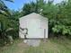 Backyard shed provides extra storage space, surrounded by lush landscaping at 1405 Dorchester St, Port Charlotte, FL 33952