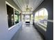 Enclosed sunroom featuring tiled flooring and ample natural light through large windows at 1405 Dorchester St, Port Charlotte, FL 33952
