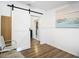 Living room with hardwood floors and a view into the kitchen at 8495 Cristobal Ave, North Port, FL 34287