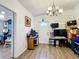 Dining area features wood floors and an updated chandelier at 8495 Cristobal Ave, North Port, FL 34287