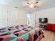 Bedroom with ceiling fan, hardwood floor, and TV stand at 8495 Cristobal Ave, North Port, FL 34287