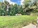Large backyard with grassy area and mature trees at 8495 Cristobal Ave, North Port, FL 34287
