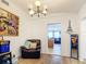 Bright dining room with hardwood floors, a comfortable recliner and a view of the kitchen at 8495 Cristobal Ave, North Port, FL 34287