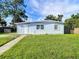 A charming light blue ranch home with a well-maintained lawn at 8495 Cristobal Ave, North Port, FL 34287
