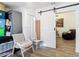 Bright living room with hardwood floors and sliding barn door at 8495 Cristobal Ave, North Port, FL 34287