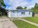 Single story house with light blue exterior and small front yard at 8495 Cristobal Ave, North Port, FL 34287