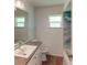 Updated bathroom features a stylish vanity, updated fixtures, and a modern shower/tub combo at 20340 Zelda Ave, Port Charlotte, FL 33952
