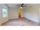 Large bedroom with wood-look floors and access to bathroom at 20340 Zelda Ave, Port Charlotte, FL 33952