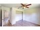Well-lit bedroom with ceiling fan and access to another room at 20340 Zelda Ave, Port Charlotte, FL 33952