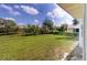 Large grassy backyard with mature trees and privacy fence at 20340 Zelda Ave, Port Charlotte, FL 33952