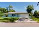 Newly built home with light blue exterior, two-car garage and well-maintained lawn at 20340 Zelda Ave, Port Charlotte, FL 33952