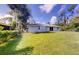 Large backyard with a grassy lawn and plenty of space at 20340 Zelda Ave, Port Charlotte, FL 33952