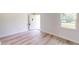 Bright living room featuring light wood-look flooring and an open floor plan at 20340 Zelda Ave, Port Charlotte, FL 33952