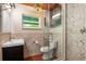 Bathroom with glass shower, patterned tile, and modern vanity at 8516 Riverside Dr, Punta Gorda, FL 33982