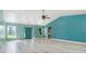Spacious living room featuring a vaulted ceiling and light wood floors at 8516 Riverside Dr, Punta Gorda, FL 33982