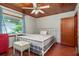 Bedroom with wood ceiling, large window, and a metal bed frame at 8516 Riverside Dr, Punta Gorda, FL 33982