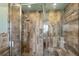 Large walk-in shower with pebble tile floor and multi-textured wall tiles at 8516 Riverside Dr, Punta Gorda, FL 33982